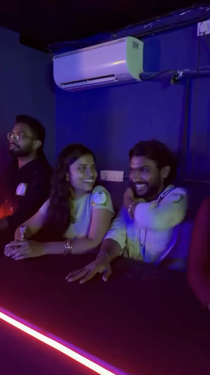 Two players laughing at the team desk