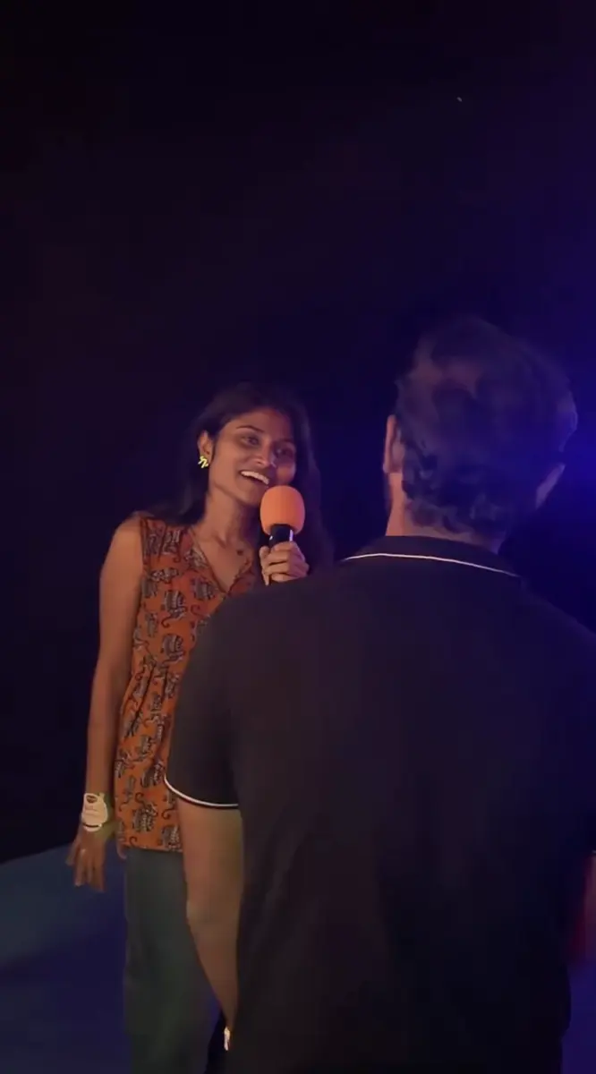 A player laughing into the mic while the host asks a question