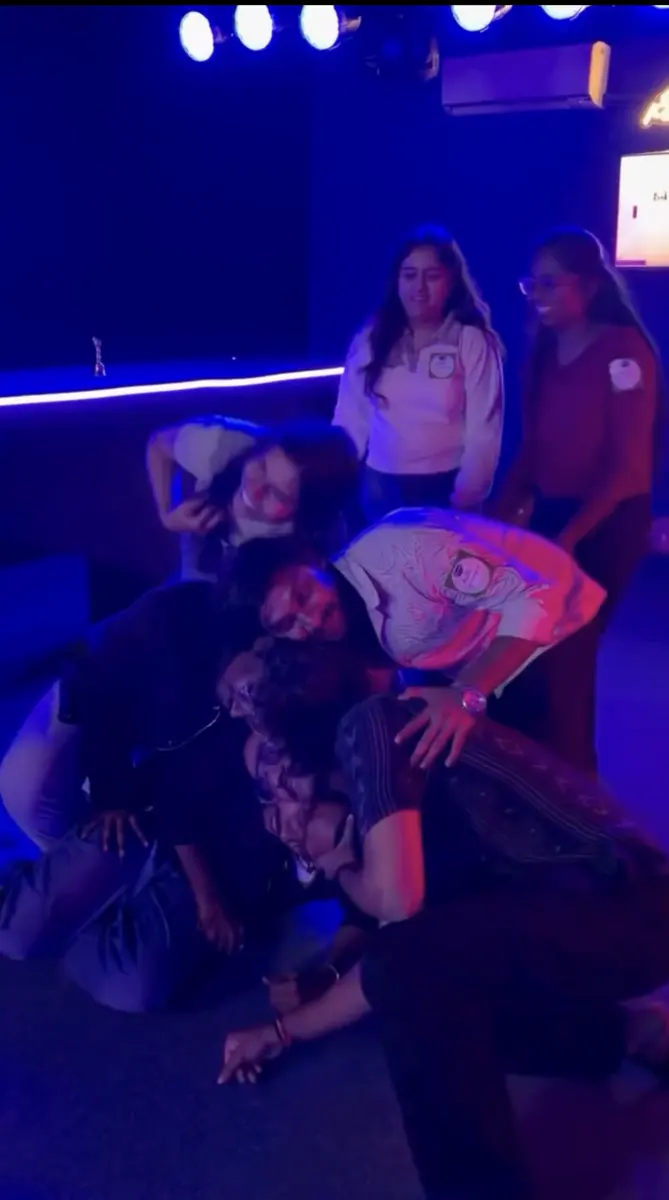 A team collapsing in laughter during a physical round