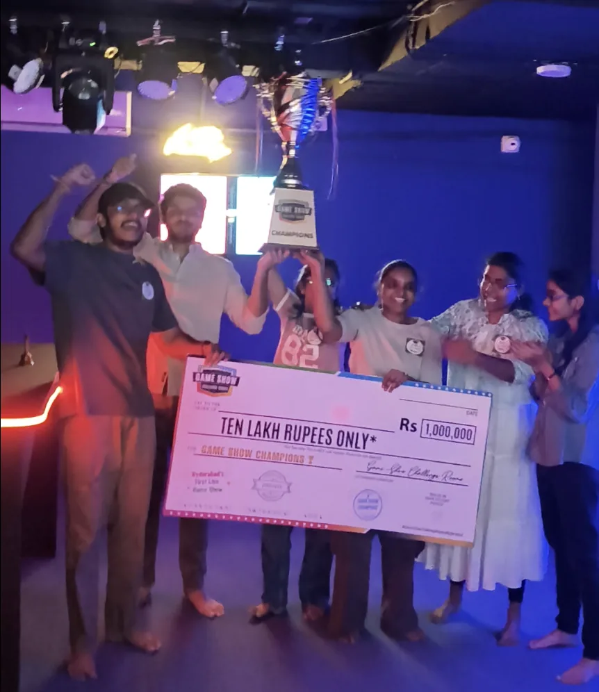 A team lifting the trophy and cheque in the arena
